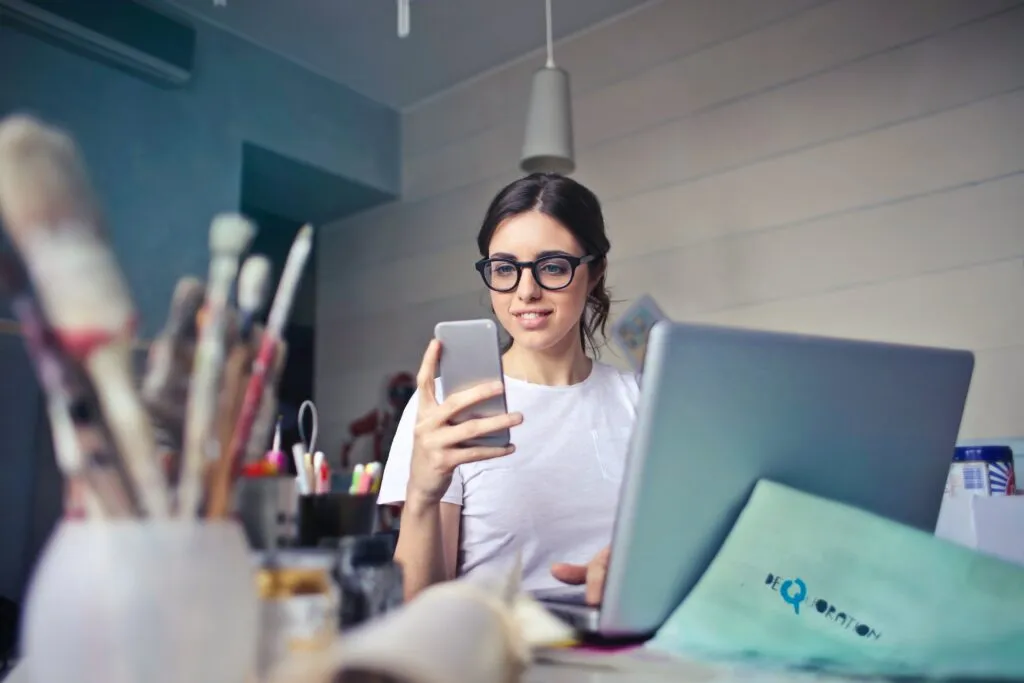 Woman with glasses looking at her phone